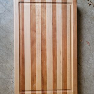 Striped cutting board with juice groove