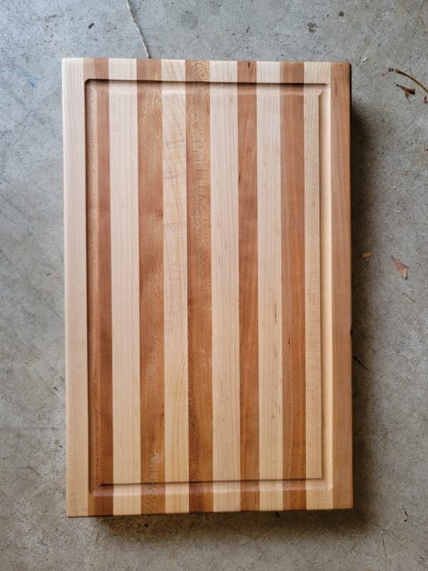 Striped cutting board with juice groove